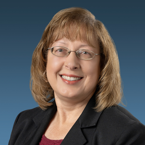 A headshot of Carolyn M. Randall with a blue backdrop.